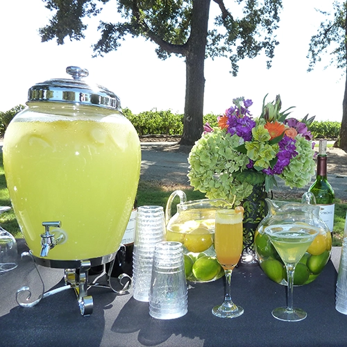 Outdoor bar with glassware and beverage catering setup.